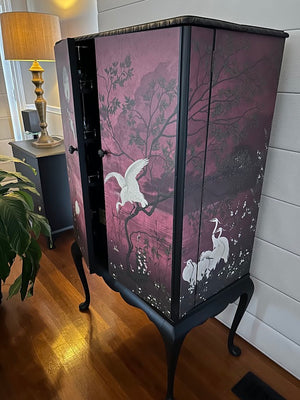 Upcycled vintage chinoiserie cabinet showing wraparound hand-painted mural on side panels — side view